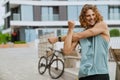 Young athletic long-haired handsome smiling man stretching his shoulder Royalty Free Stock Photo