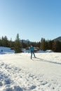 Young athletic man enjoys a nordic skiing workout on a beautiful winter day