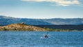 Young athletic man on his kayak canoeing and enjoying alone the tranquility of Aguilar dam