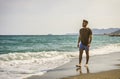 Young athletic man walking at the beach Royalty Free Stock Photo