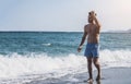 Young athletic man walking at the beach Royalty Free Stock Photo