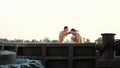 Young athletic men with bare, naked torsos, box, practice the technique of strikes, capture, fight, on a sandy beach, in