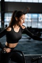 Young Athletic middle aged woman training on air resistance bike, cross training workout set in gym. Active woman spinning a air Royalty Free Stock Photo