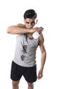 Young athletic sport man thirsty holding bottle of water with sweaty face and wet singlet Royalty Free Stock Photo