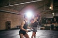 Young athletic sportspeople lifting weights in gym