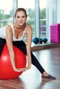 Young athletic woman doing exercises with fitness ball in gym Royalty Free Stock Photo