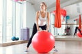 Young athletic woman doing exercises with fitness ball in gym Royalty Free Stock Photo