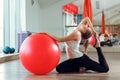 Young athletic woman doing exercises with fitness ball in gym Royalty Free Stock Photo