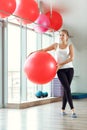 Young athletic woman doing exercises with fitness ball in gym Royalty Free Stock Photo