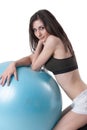 Young athletic woman exercised with a blue stability ball Royalty Free Stock Photo