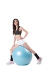 Young athletic woman exercised with a blue stability ball Royalty Free Stock Photo