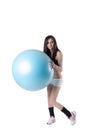 Young athletic woman exercised with a blue stability ball Royalty Free Stock Photo