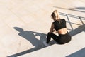 Young athletic woman and her shadow during summer workout Royalty Free Stock Photo