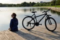 Young athletic woman in sportswear sits next to a bicycle Royalty Free Stock Photo