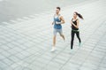 Young woman and man jogging in city copy space Royalty Free Stock Photo