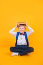 Young atractive boy wearing school unifor while holding his school books on heard Royalty Free Stock Photo