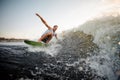 Young attractive active man riding on the wakeboard on the lake Royalty Free Stock Photo