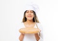 Young attractive african american woman in cooking hat holding empty wood pizza cutting board isolated on white background. Copy Royalty Free Stock Photo