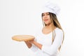 Young attractive african american woman in cooking hat holding empty wood pizza cutting board isolated on white background. Copy Royalty Free Stock Photo