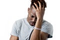 Young attractive afro american man on his 20s looking sad and depressed posing emotional Royalty Free Stock Photo