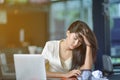 Young attractive Asian business woman sleeping, drowsing or taking a nap at her desk, Tired business woman accountant with bills Royalty Free Stock Photo