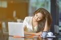 Young attractive Asian business woman sleeping, drowsing or taking a nap at her desk, Tired business woman accountant with bills Royalty Free Stock Photo