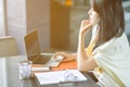 Young attractive Asian business woman sleeping, drowsing or taking a nap at her desk, Tired business woman accountant with bills Royalty Free Stock Photo