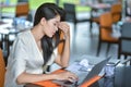 Young attractive Asian business woman sleeping, drowsing or taking a nap at her desk, Tired business woman accountant with bills Royalty Free Stock Photo