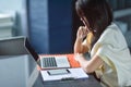 Young attractive Asian business woman sleeping, drowsing or taking a nap at her desk, Tired business woman accountant with bills