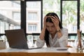 Young attractive Asian business woman sleeping, drowsing or taking a nap at her desk, Tired business woman accountant Royalty Free Stock Photo