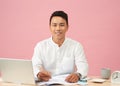 Young attractive asian businessman using laptop sitting on desk table in office Royalty Free Stock Photo