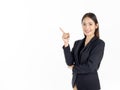 A young attractive Asian businesswoman in black suit pointing finger to present isolated on white background Royalty Free Stock Photo