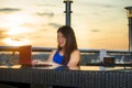 Young attractive Asian Chinese business woman working online with laptop computer from rooftop sky bar on beautiful sunset as Royalty Free Stock Photo