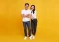 Young attractive Asian couple man and woman happy and hugging on yellow background. Concept for love photography Royalty Free Stock Photo
