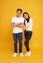 Young attractive Asian couple, man and woman wearing white t shirt and jeans. Teasing each other. Concept for pre wedding