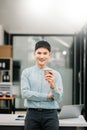 Young attractive Asian male office worker business smiling at camera in office Royalty Free Stock Photo