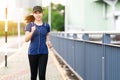 Young attractive asian runner woman running in city street or foot path way listen to music Royalty Free Stock Photo