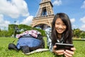 Young attractive asian tourist smartphone tablet in Paris