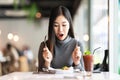 Young attractive asian woman holding fork and spoon feeling hungry, excited Royalty Free Stock Photo