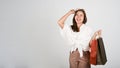 Young attractive Asian woman holding shopping bags, white  background Royalty Free Stock Photo