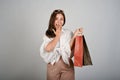 Young attractive Asian woman holding shopping bags, feeling excited with special discount Royalty Free Stock Photo