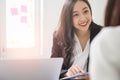 A young attractive asian woman is interviewing for a job. Her interviewers are diverse. Royalty Free Stock Photo