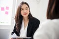 A young attractive asian woman is interviewing for a job. Her interviewers are diverse. Royalty Free Stock Photo