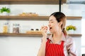 Young attractive Asian woman recording cooking lesson online live streaming vlogger in the kitchen. Work from home concept. social Royalty Free Stock Photo