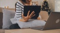 Young attractive asian woman resting using browsing tablet computer on sofa at home, happy girl sitting on couch relax reading Royalty Free Stock Photo