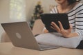 Young attractive asian woman resting using browsing tablet computer on sofa at home, happy girl sitting on couch relax reading Royalty Free Stock Photo