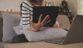 Young attractive asian woman resting using browsing tablet computer on sofa at home, happy girl sitting on couch relax reading Royalty Free Stock Photo