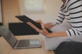 Young attractive asian woman resting using browsing tablet computer on sofa at home, happy girl sitting on couch relax reading Royalty Free Stock Photo