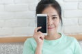 Young Asian woman taking selfie photo in bedroom