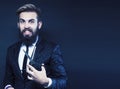 young attractive bearded hipster man gesturing emotional screaming in studio sucsess. fashion modern brutal guy Royalty Free Stock Photo